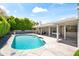 Backyard pool with flagstone decking, adjacent to a covered patio and lush landscaping at 8007 E Del Tesoro Dr, Scottsdale, AZ 85258