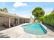 Relaxing backyard pool area with flagstone decking, covered patio, and mature trees at 8007 E Del Tesoro Dr, Scottsdale, AZ 85258