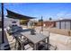 Inviting backyard with shaded dining area, gravel, and stylish outdoor furniture, perfect for relaxation at 8022 E Columbus Ave, Scottsdale, AZ 85251