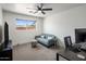 Cozy bedroom with a ceiling fan and large window for natural light at 8022 E Columbus Ave, Scottsdale, AZ 85251