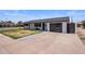 Charming single-story home featuring a modern garage and well-maintained landscaping at 8022 E Columbus Ave, Scottsdale, AZ 85251