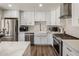 Modern kitchen with stainless steel appliances, white subway tile backsplash, and white cabinets at 8022 E Columbus Ave, Scottsdale, AZ 85251