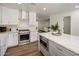 Open kitchen featuring quartz counters, stainless appliances and white cabinets at 8022 E Columbus Ave, Scottsdale, AZ 85251
