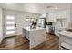 Bright kitchen with waterfall island, stainless appliances, white cabinets, and wood-look floors at 8022 E Columbus Ave, Scottsdale, AZ 85251