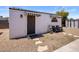 This outbuilding features black and white awnings over the door and window at 8022 E Columbus Ave, Scottsdale, AZ 85251