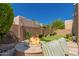 Beautiful backyard with a fire pit, putting green, and well-manicured landscaping at 8324 E Cactus Wren Rd, Scottsdale, AZ 85250