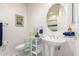 Bright bathroom with a pedestal sink and decorative glass block shelf at 8324 E Cactus Wren Rd, Scottsdale, AZ 85250