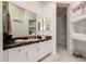 Bathroom featuring white cabinets, granite countertops, and large mirrors above the sink at 8324 E Cactus Wren Rd, Scottsdale, AZ 85250