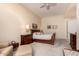 Primary bedroom with a ceiling fan, carpeted floors, and a wooden sleigh bed at 8324 E Cactus Wren Rd, Scottsdale, AZ 85250
