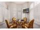 Bright breakfast nook featuring white shuttered windows and seating for four at 8324 E Cactus Wren Rd, Scottsdale, AZ 85250