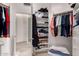Walk-in closet featuring shelving, storage, and access to bathroom at 8324 E Cactus Wren Rd, Scottsdale, AZ 85250