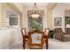 Elegant dining area featuring a pendant light fixture and seating for six at 8324 E Cactus Wren Rd, Scottsdale, AZ 85250
