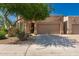 Charming single-story home featuring a two-car garage, desert landscaping, and a cozy front entrance at 8324 E Cactus Wren Rd, Scottsdale, AZ 85250