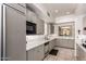 Modern kitchen with stainless steel appliances, ample cabinet space and quartz countertops at 8324 E Cactus Wren Rd, Scottsdale, AZ 85250