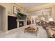 Open living area with fireplace, TV and a view into the dining room at 8324 E Cactus Wren Rd, Scottsdale, AZ 85250