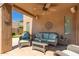 Relaxing covered patio with comfortable seating and a ceiling fan at 8324 E Cactus Wren Rd, Scottsdale, AZ 85250