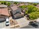 Stunning aerial view of a two-story home with a three-car garage nestled in a vibrant, green neighborhood at 8621 W Morten Ave, Glendale, AZ 85305