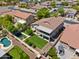 Aerial view of home with pool, artificial turf backyard, and upstairs balcony at 8621 W Morten Ave, Glendale, AZ 85305