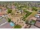 Aerial view featuring a park, pool and lush neighborhood with mature trees at 8621 W Morten Ave, Glendale, AZ 85305