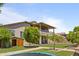 Expansive backyard with artificial lawn, mature trees, storage shed and covered patio at 8621 W Morten Ave, Glendale, AZ 85305