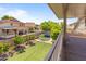 Upstairs balcony overlooking lush backyard, mature landscaping, and neighborhood at 8621 W Morten Ave, Glendale, AZ 85305