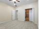 Bedroom featuring neutral walls, carpet, a ceiling fan, and access to the ensuite bathroom at 8621 W Morten Ave, Glendale, AZ 85305