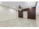 Large bedroom featuring light wood floors and a dark wood built-in cabinet with doors at 8621 W Morten Ave, Glendale, AZ 85305