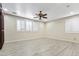 Spacious bedroom with light wood floors, neutral walls and large windows with classic white shutters at 8621 W Morten Ave, Glendale, AZ 85305
