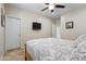 Comfortable bedroom offering a ceiling fan, tile floors, closet, and relaxing atmosphere for rest and privacy at 8621 W Morten Ave, Glendale, AZ 85305