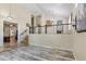 Spacious entryway showcasing wood-look floors, a wrought iron railing staircase, and a view into other rooms at 8621 W Morten Ave, Glendale, AZ 85305