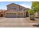 Inviting two-story home with a three-car garage and beautiful desert landscaping, perfect for curb appeal at 8621 W Morten Ave, Glendale, AZ 85305
