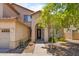 Inviting entryway with a decorative front door, complemented by lush plants and stylish desert landscaping at 8621 W Morten Ave, Glendale, AZ 85305