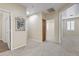 Upstairs hallway that features carpet flooring, a storage closet, and natural lighting at 8621 W Morten Ave, Glendale, AZ 85305