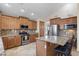 Beautiful kitchen with granite countertops, stainless steel appliances, and large central island with bar seating at 8621 W Morten Ave, Glendale, AZ 85305