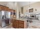 Open-concept kitchen featuring granite countertops, stainless steel appliances, a large island, and seamless flow to dining at 8621 W Morten Ave, Glendale, AZ 85305