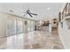 Expansive living room featuring tile floors, sliding glass doors, and seamless flow to outdoor spaces at 8621 W Morten Ave, Glendale, AZ 85305
