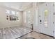 Bright living room features beautiful wood-look floors, large windows with shutters, and a welcoming atmosphere at 8621 W Morten Ave, Glendale, AZ 85305