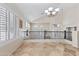 Bright loft area with high ceilings, tile floors, and plantation shutters exudes spaciousness and modern charm at 8621 W Morten Ave, Glendale, AZ 85305