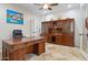 Home office showcasing a large desk, built-in wooden bookcase, and neutral wall paint at 8621 W Morten Ave, Glendale, AZ 85305
