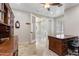 Bright home office featuring a wooden desk, tile floors, and french doors leading to another room at 8621 W Morten Ave, Glendale, AZ 85305