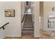 Carpeted staircase with dark handrails, leading to the second floor of the home at 8621 W Morten Ave, Glendale, AZ 85305