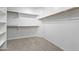 Walk-in closet with carpet and built-in shelving and hanging rods at 8621 W Morten Ave, Glendale, AZ 85305