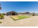 Expansive backyard with gravel landscaping, partial lawn, patio area, providing a tranquil outdoor space at 8735 N 185Th Ave, Waddell, AZ 85355