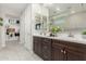 Elegant bathroom with double vanity, walk-in closet, framed mirrors, and tiled floors at 8735 N 185Th Ave, Waddell, AZ 85355