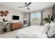 Bright bedroom features a ceiling fan, modern furniture, decorative accents, and window with natural light at 8735 N 185Th Ave, Waddell, AZ 85355