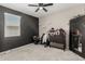 Bedroom with carpet, dark accent wall, and a dresser at 8735 N 185Th Ave, Waddell, AZ 85355