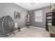Comfortable bedroom design with contemporary decor, gray walls, accent chair, and shelving unit at 8735 N 185Th Ave, Waddell, AZ 85355