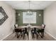Charming dining room features a wooden table with black chairs, modern light fixture, and neutral wall colors at 8735 N 185Th Ave, Waddell, AZ 85355