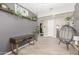 Stylish entryway with wooden desk, decorative plants, modern decor, and tile flooring at 8735 N 185Th Ave, Waddell, AZ 85355
