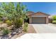 Charming single-story home featuring a well-maintained yard and a neutral stucco finish at 8735 N 185Th Ave, Waddell, AZ 85355